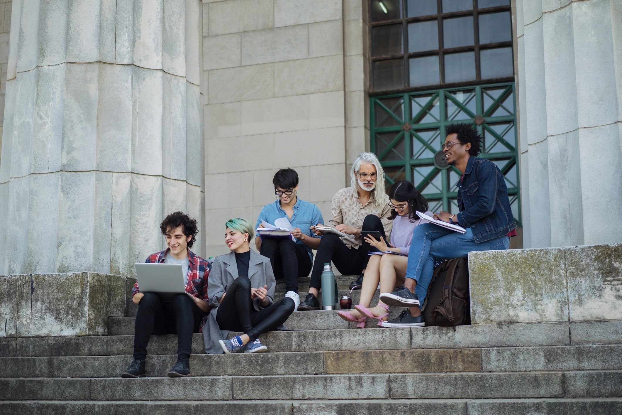 Students learning outdoors with a professor on campus