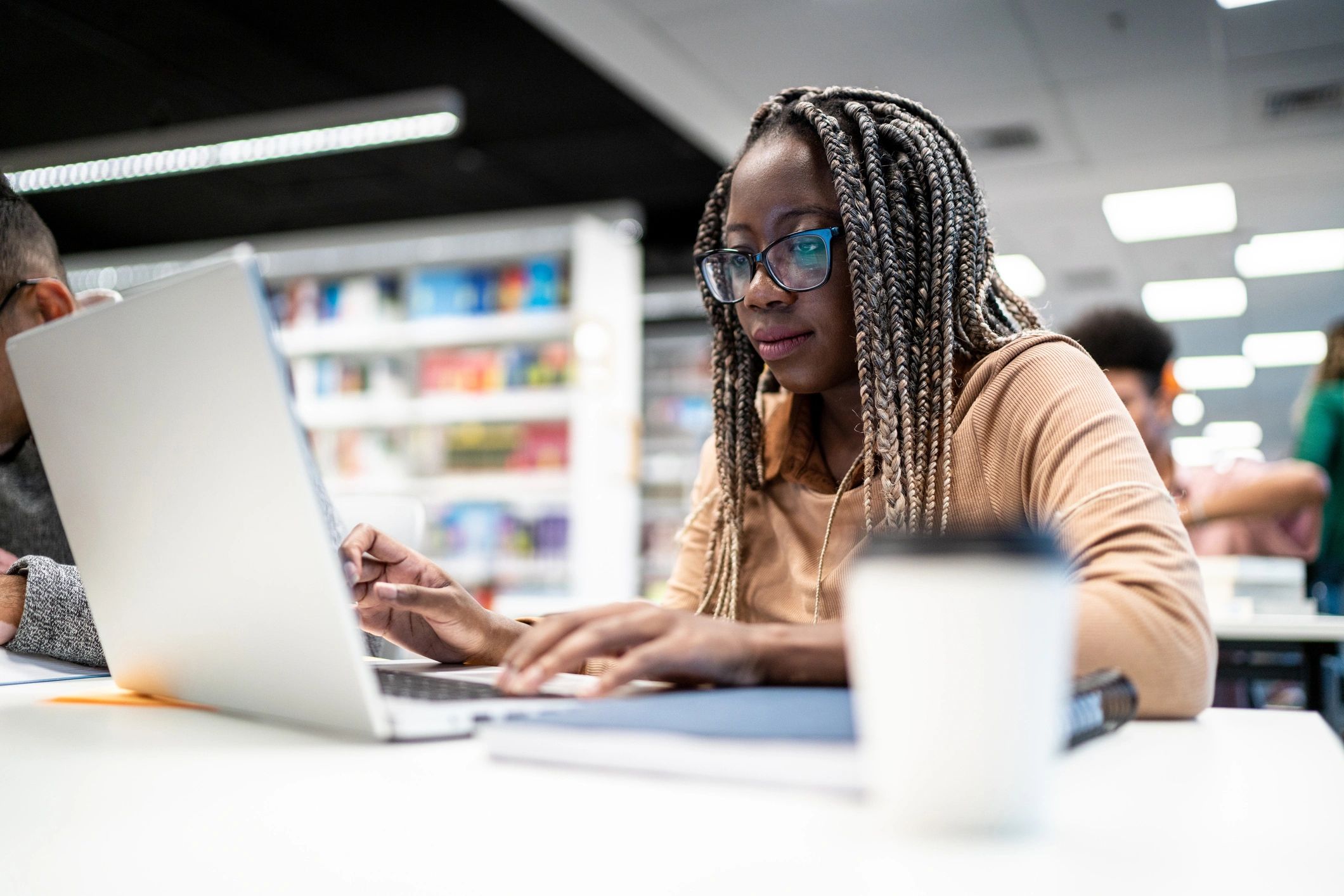 Student studying with a laptop in a university library