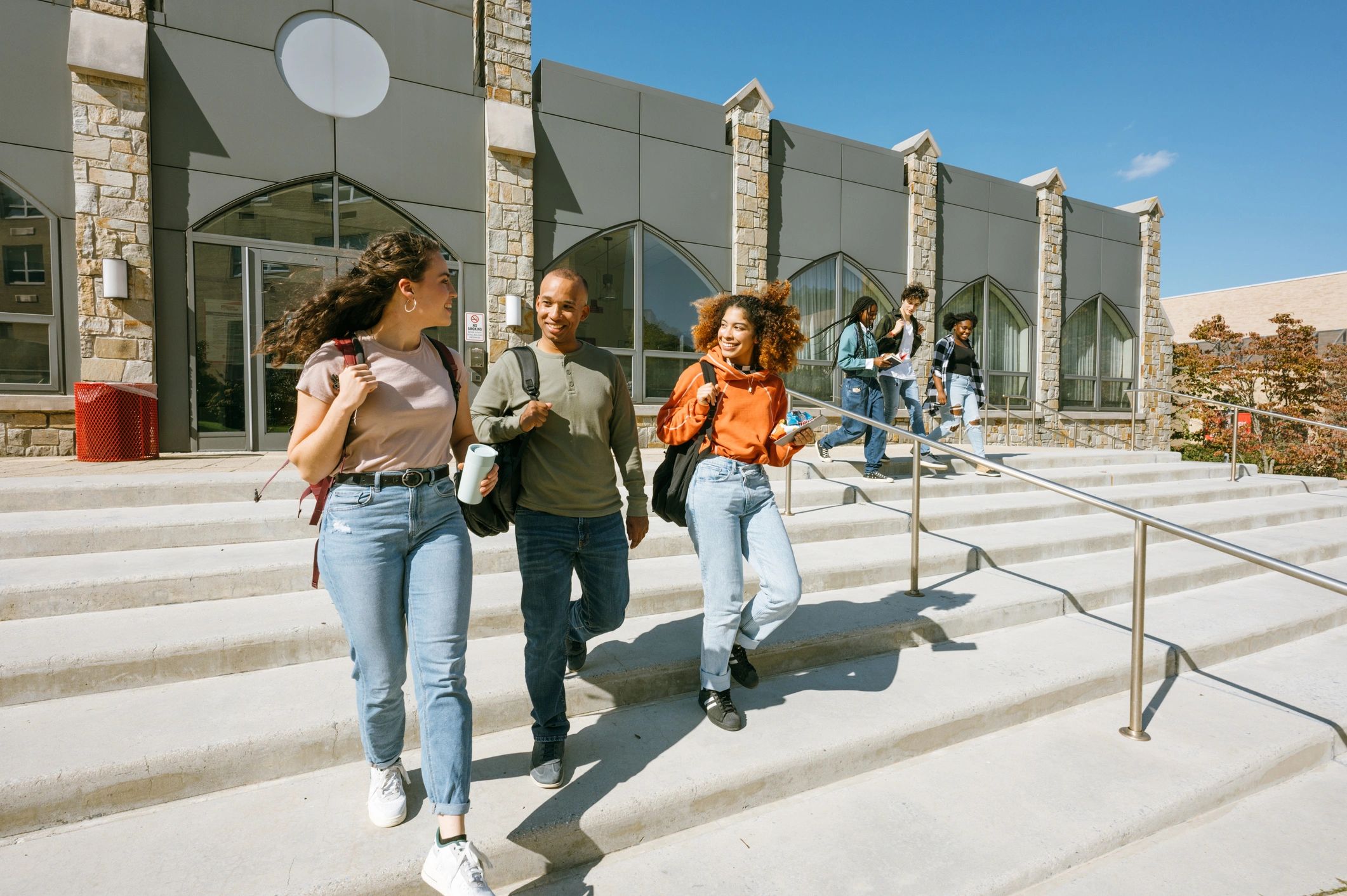 Students leaving a university building with backpacks