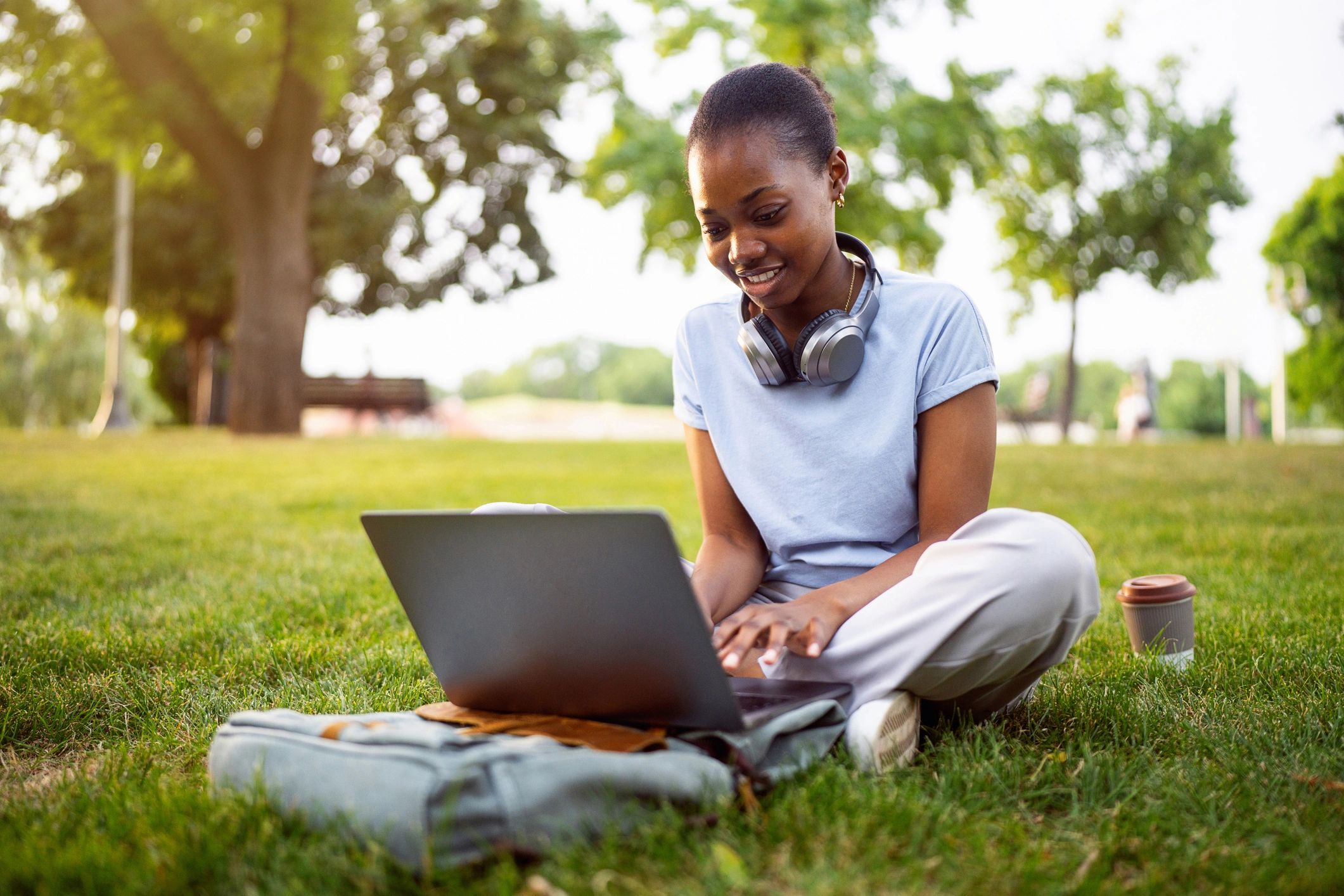 Student e-learning on a laptop outdoors
