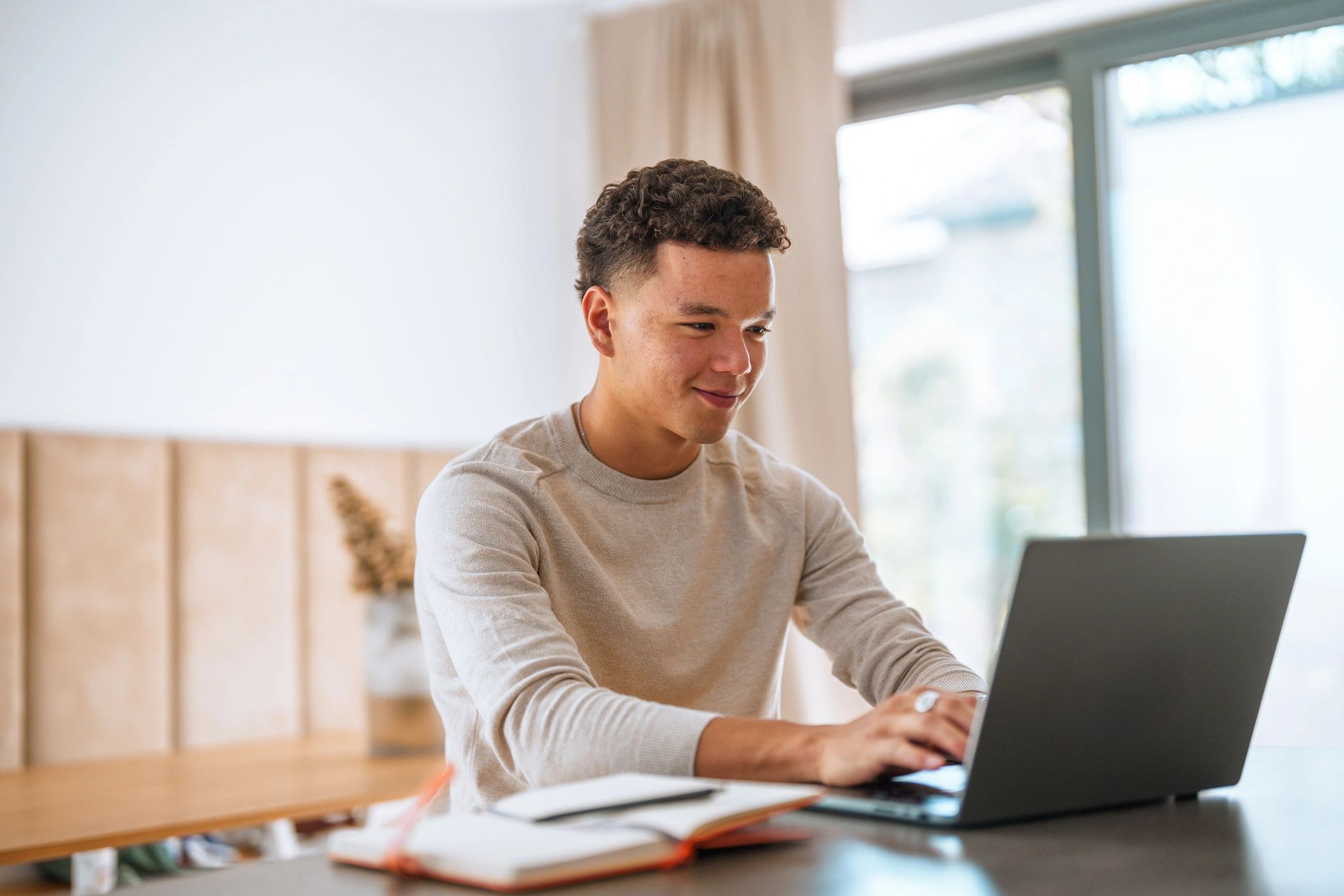 Student working on laptop at home