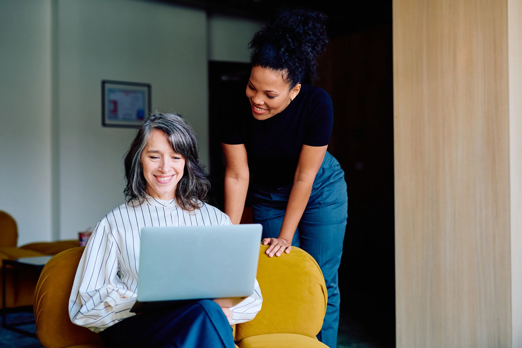 Advisor mentoring a student using a laptop
